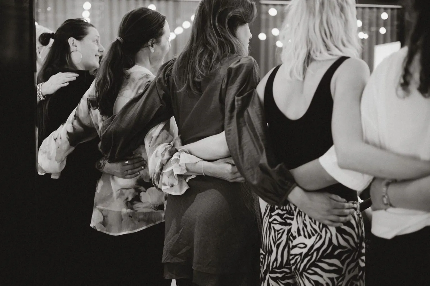 Participants at Fully Alive in Stockholm standing close with their arms around each other